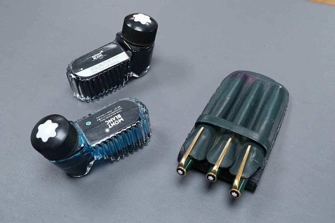 Three Mont Blanc pens in a green leather Mount Blanc case and two inkwells.